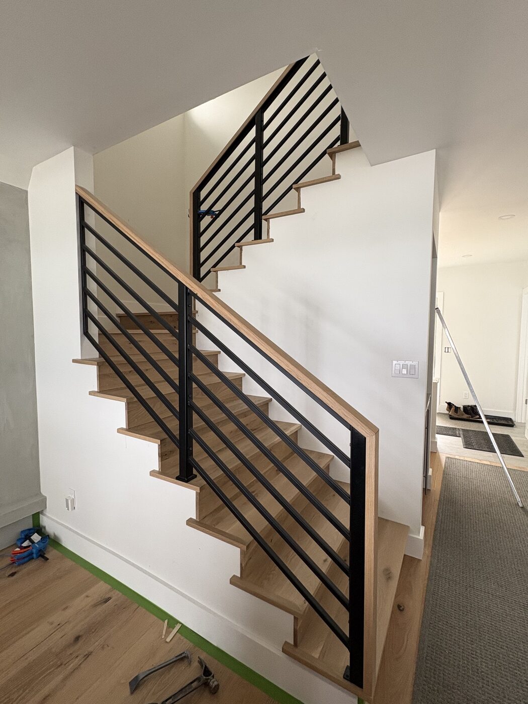 Lake Michigan beach house stair rail with oak handrail cap