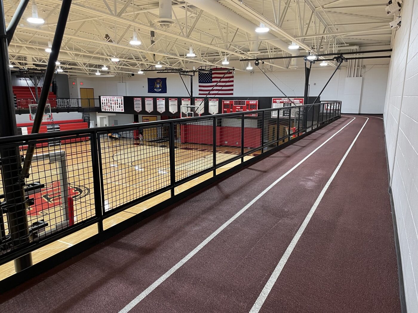 High school gym mezzanine mesh railing along indoor track