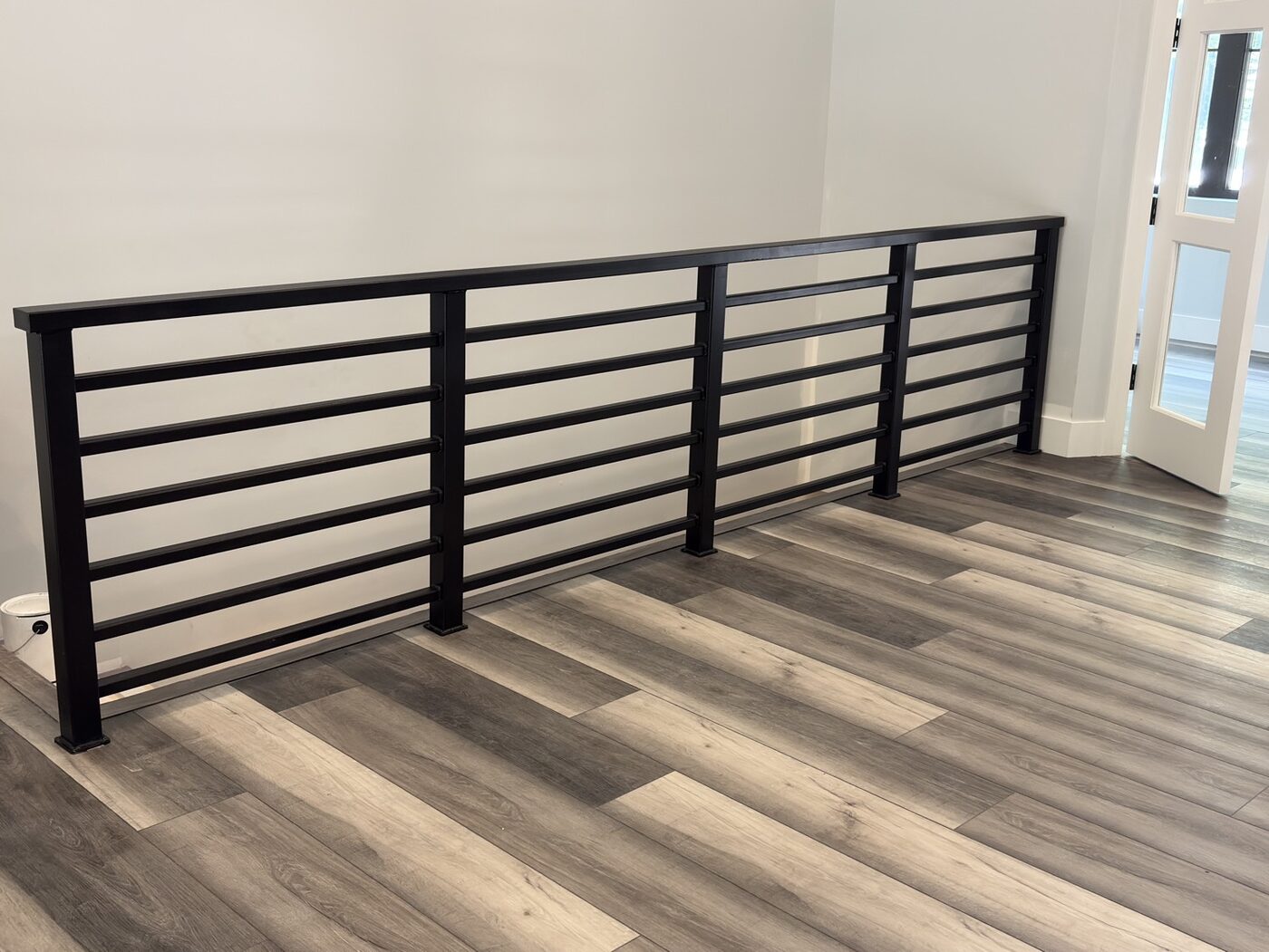 Black horizontal-bar interior handrail in new home