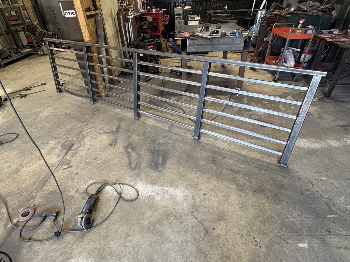 Raw steel handrail sections before paint